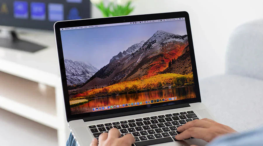Customer checking MacBook Pro condition before purchase at PayMore Roswell